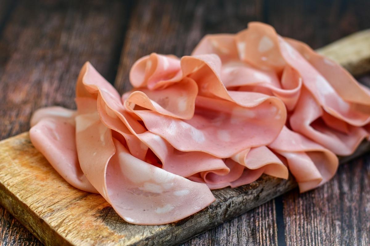 Tagliere di legno con mortadella a fette