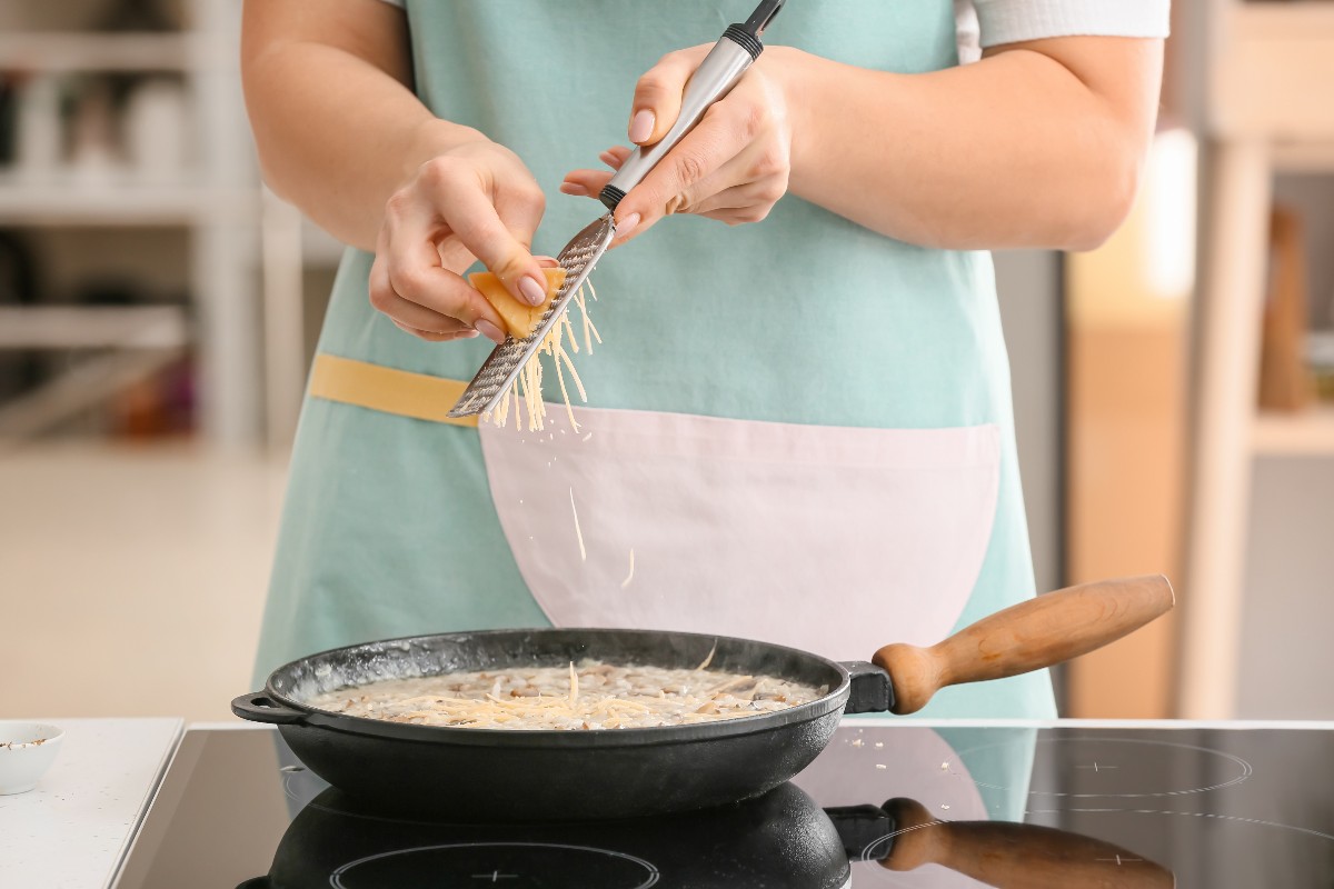 Aggiunta del parmigiano al risotto in padella