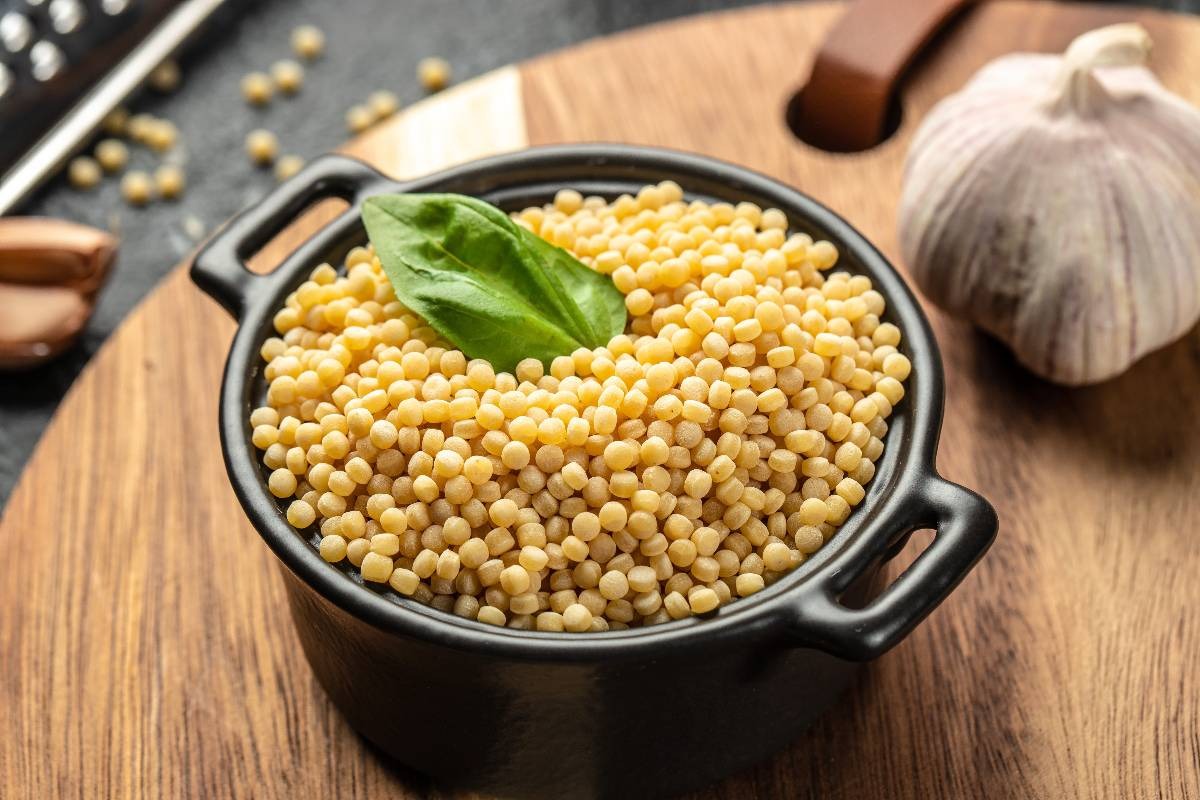 Ciotola nera con fregola, pasta sarda