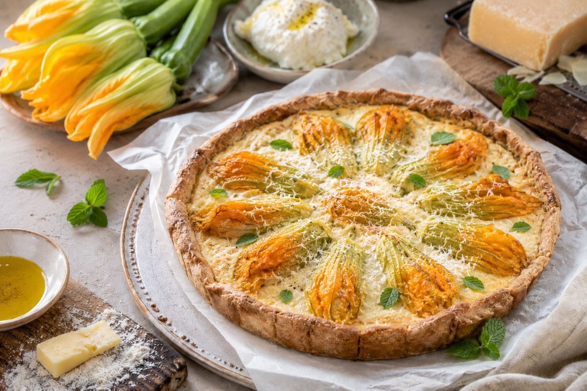 Torta salata con fiori di zucca ripieni disposti a raggiera