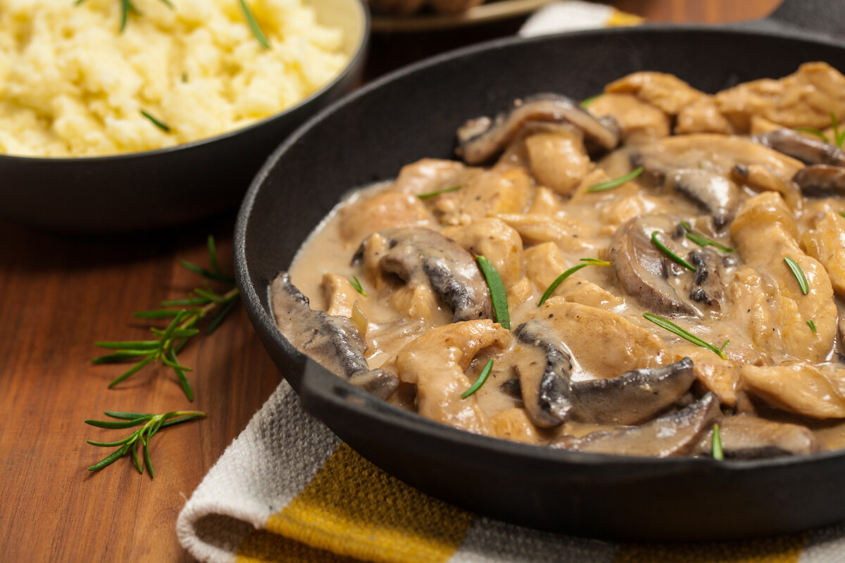 Padella con scaloppine ai funghi e purè sullo sfondo