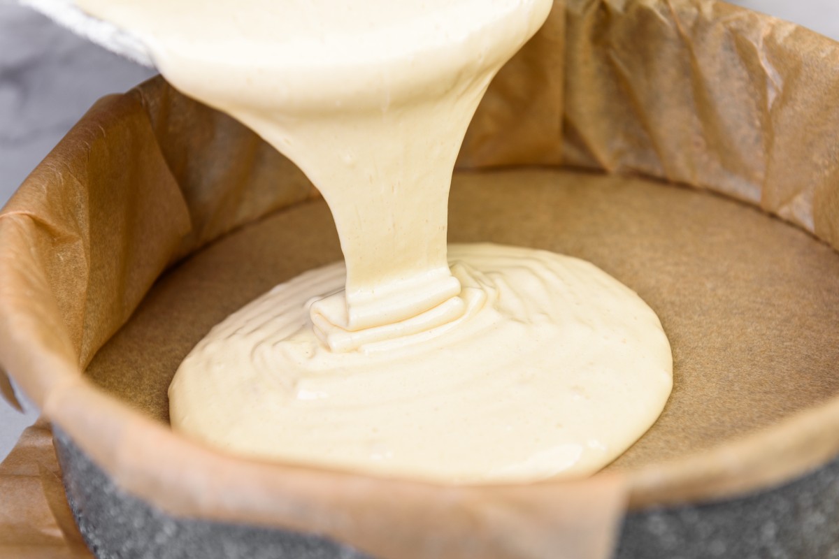 Cake dough poured into a baking tray lined with baking paper