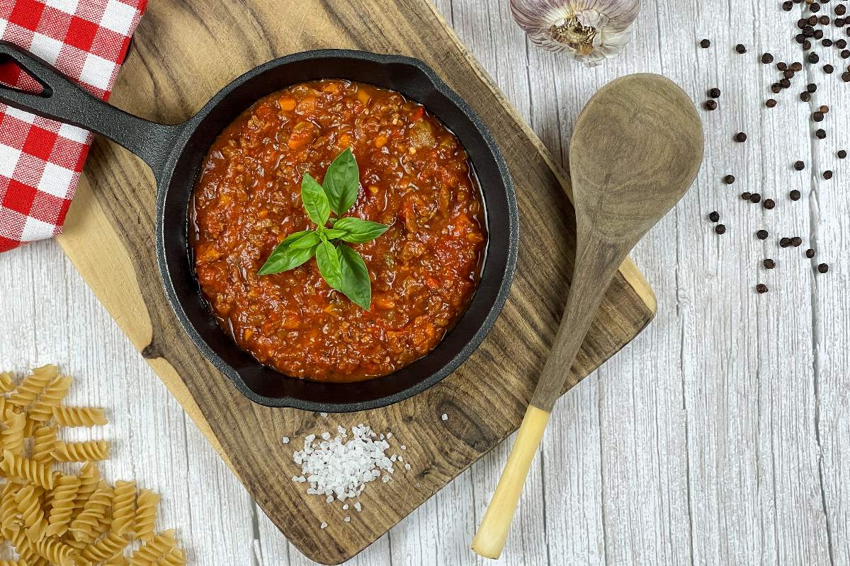 Top view pan with cooked lentil ragù and pasta to be cooked