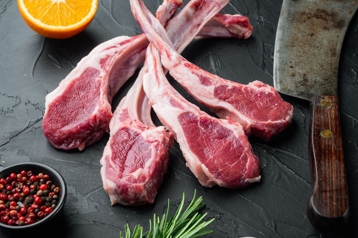 Lamb chops with orange, rosemary and pink pepper and meat knife