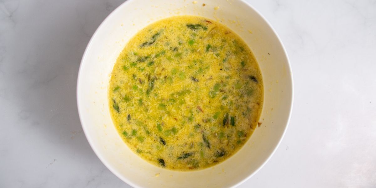 Add asparagus to egg mixture