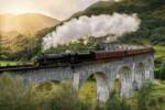 Trano a vapore mentre attraversa un ponte in Scozia al tramonto